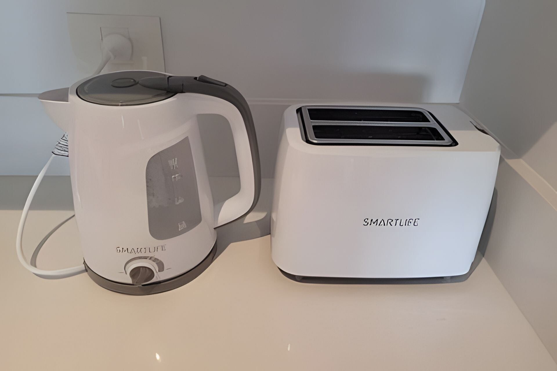 A kitchen with a kettle and a toaster.