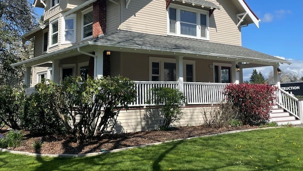 A two-story house with a porch, a chimney, and a well-maintained lawn. - Relax Inn The Grove (Forest Grove)