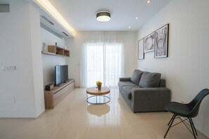 Exclusive Apartment, Courtyard Area | Living area | 50-inch Smart TV with digital channels, Netflix, heated floors