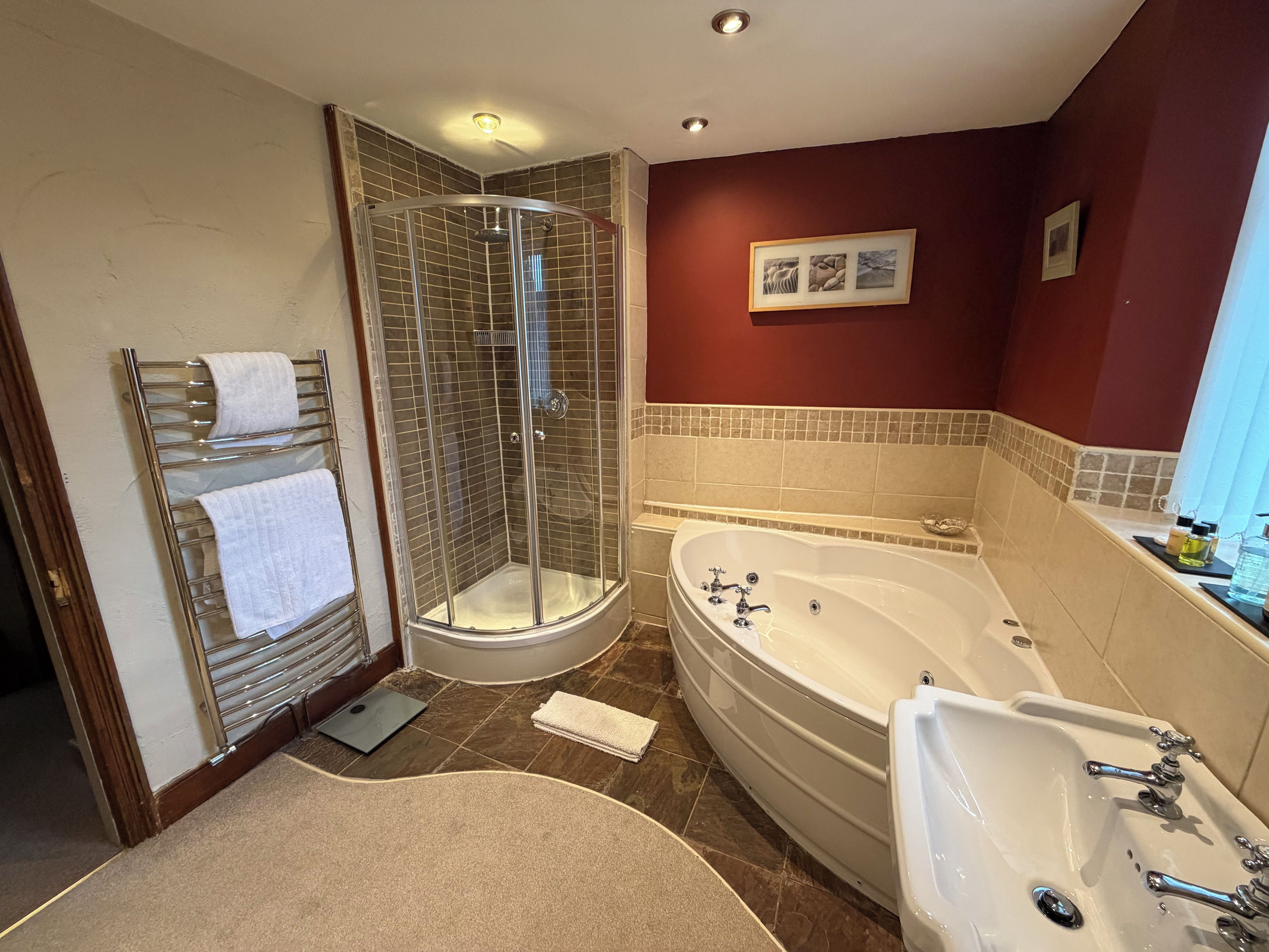 A bathroom with a walk-in shower, a bathtub, and a sink.