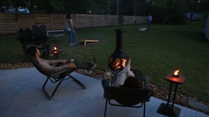 A patio area with a grill and seating. - On the water 5 mins from Emerald Isle. Awesome kayaking with kayaks and Launch! (Swansboro)