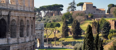 A historic site with ancient ruins, including a large arch and a tower.