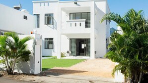 A modern two-story white building with a flat roof, large windows, and a covered entrance. - 4 Bedroom Private Villa Villa La Tourelle (Tamarin)