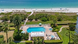 A resort with a pool, beach, and ocean view.