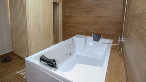 A modern bathroom with a freestanding bathtub, wooden panel walls, and a wooden floor. - Ethno Village Dolina Mira - One Bedroom Holiday Home (Drina) (Pale)