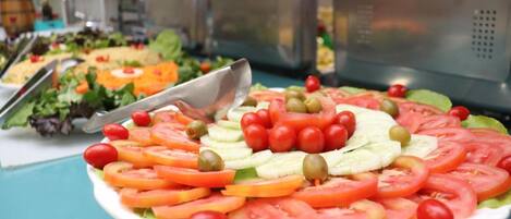 A buffet with a variety of salads and dishes.