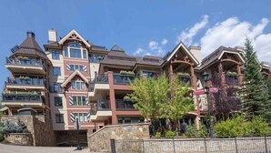 A multi-story hotel with balconies, stone facade, and a clear sky. - Ski In, Ski Out 1 Bedroom at the Eagle Bahn Gondola in Lionshead (Vail)