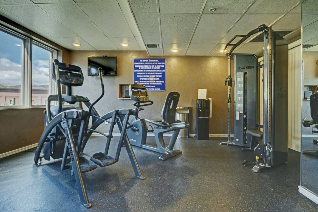 A gym with treadmills, a stationary bike, and a weight machine.