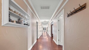 A long hallway with wooden floors and white walls, leading to multiple doors. - Downtown loft in the heart of Lodi. Great for large groups! (Lodi)