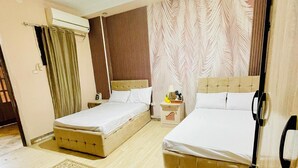 A double room with two beds, a large decorative rug, a ceiling light, and a window with curtains. - Narmar Hotel (Giza)