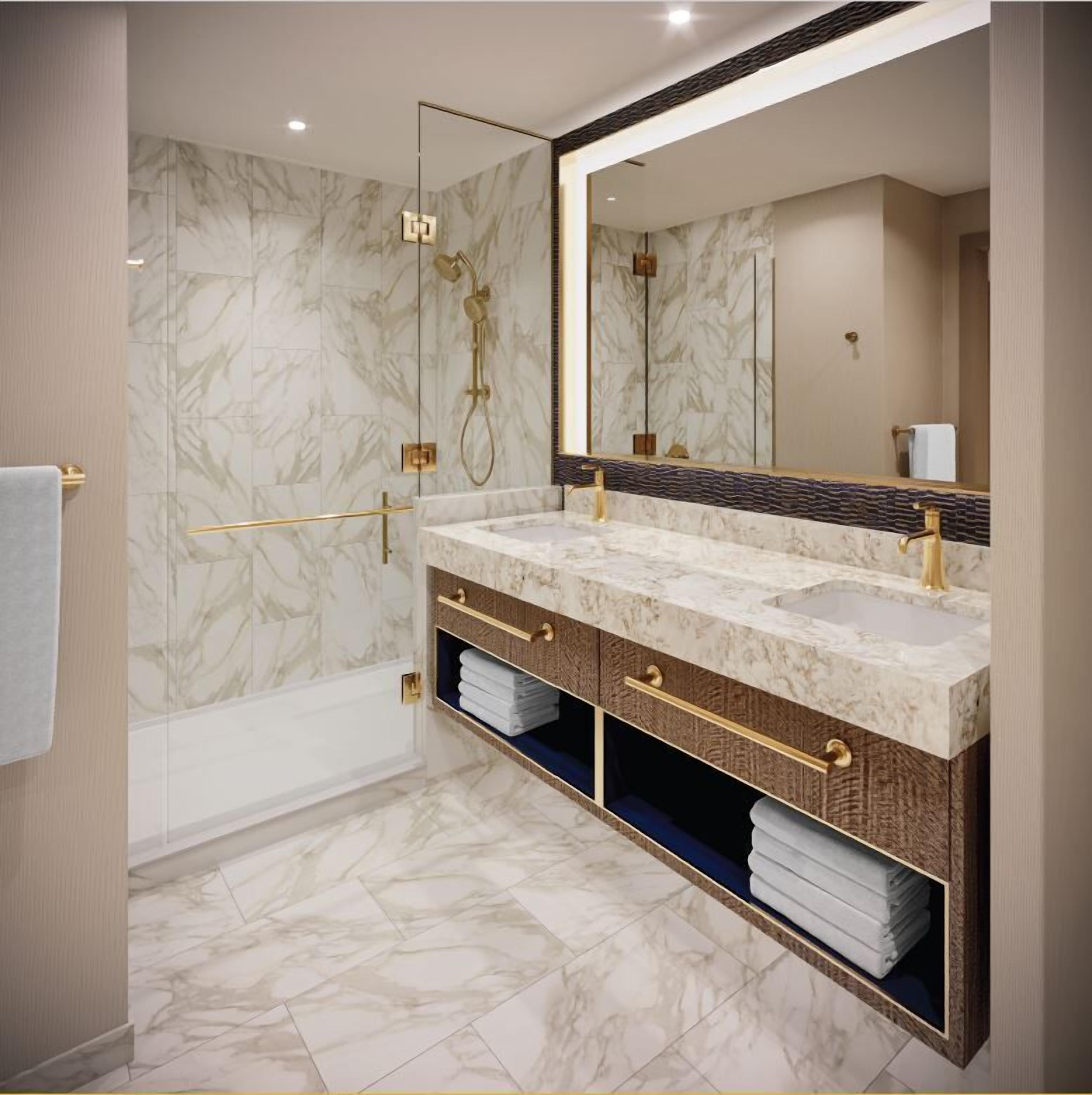 Une salle de bain moderne dotée d’une douche à l’italienne, d’un grand meuble-lavabo avec deux vasques et d’un miroir au-dessus du lavabo.