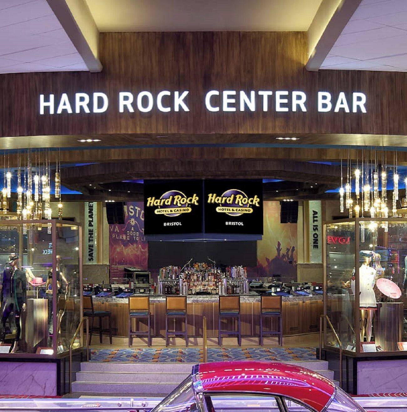 A Hard Rock Center Bar with a bar area, multiple TVs displaying the Hard Rock logo, and a 'Save the Planet' banner.