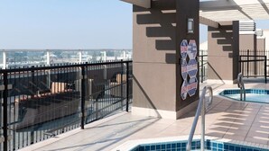 A rooftop pool area with a hot tub, a glass balustrade, and a view of the cityscape. - WorldMark Anaheim - 2 Bedroom Presidential Accessible (Anaheim)
