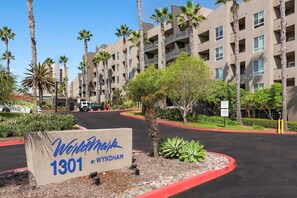 A multi-story hotel with a sign reading 'Wyldham 1301 by Wyndham.'