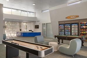 A pool table, billiards, a reception desk, a vending machine, and a pool table.