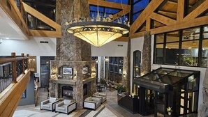 A spacious lobby with a stone fireplace, comfortable seating, and a large chandelier. - Ski in and out, Canyons, Westgate, King, Kitchen, Free Breakfast, Coffee & Tea Bar, Steam, Pool, HT (Park City)