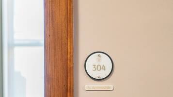 A door with a number plate labeled "304" and an "Accessible" sign.