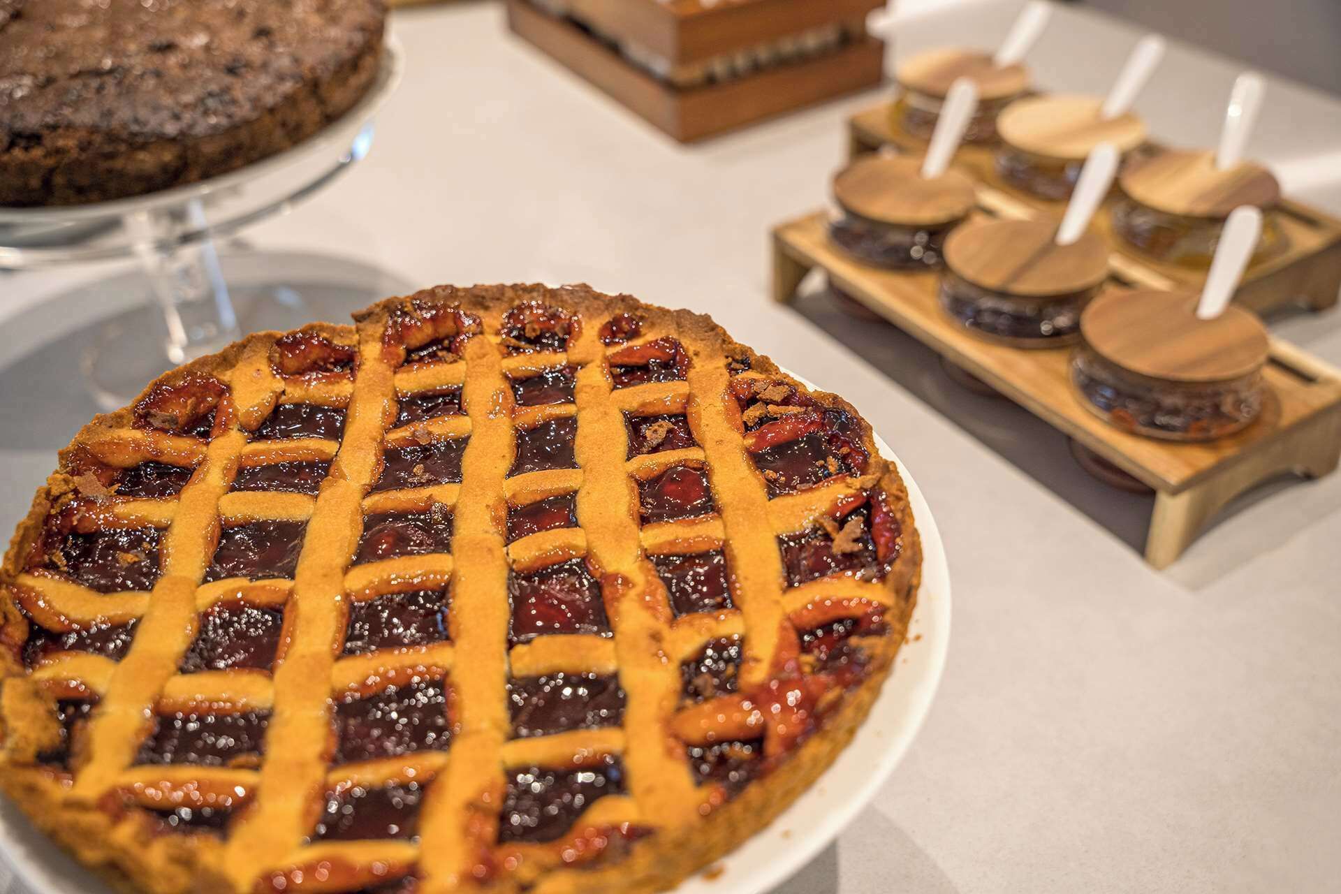 A pie with a lattice crust on a white plate.