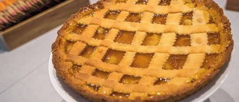 A pie with a lattice crust on a white plate.