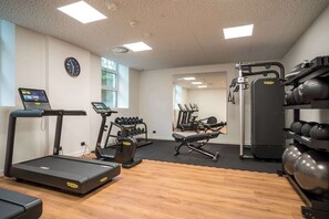 Stay fit on the go with our fully equipped gym featuring a treadmill, stationary bike, dumbbells, bench press, and weight bench.