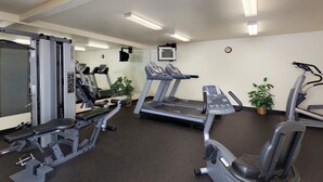 A gym with treadmills, weight machines, and a mirror. - Solvang | Wine Country Hideaway | Pool & Village Walks (Solvang)