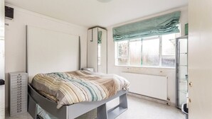 A bedroom with a bed, a wardrobe, a radiator, and a window with curtains. - Central one bedroom flat. CONTACT ME BEFORE BOOKING TO CHECK AVAILABILITY (London)