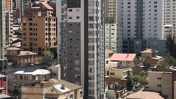 A high-rise building with multiple floors, surrounded by other buildings.