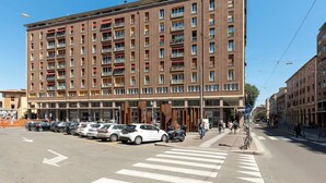 Ein mehrstöckiges Gebäude mit einer Reihe geparkter Autos davor.