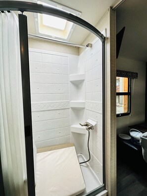 Shower, towels, soap, toilet paper