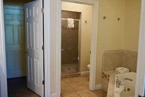 A bathroom with a shower, toilet, and sink.