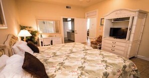 A bedroom with a bed, dresser, TV, and a door leading to a bathroom. - 2 Bedroom, 2 Bathroom Deluxe Partial  Bay View. Pet Friendly (Bradenton Beach)