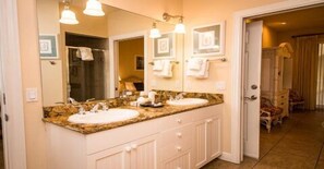 A bathroom with two sinks, a large mirror, and a vanity with drawers. - 2 Bedroom, 2 Bathroom Deluxe Partial  Bay View. Pet Friendly (Bradenton Beach)
