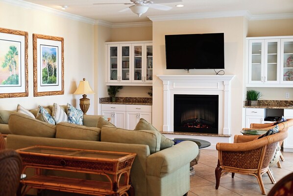 A living room with a fireplace, television, and furniture.