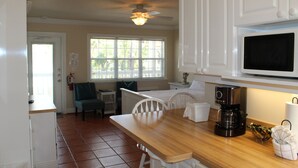 A kitchen with a wooden countertop, a coffee maker, a microwave, and a ceiling fan. - Bright Second-Floor Studio Near the Beach (Bradenton Beach)