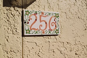 Una placa con el número de la casa en una pared con textura.