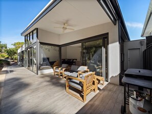 Relax in style on the spacious deck, surrounded by comfortable seating and a seamless transition to the patio.