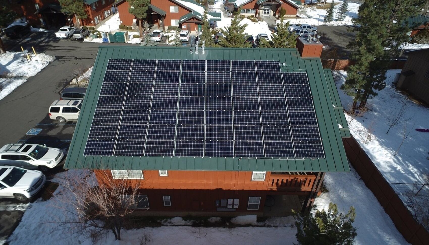 A building with a green roof and solar panels.