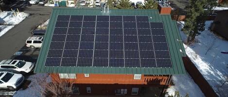 A building with a green roof and solar panels.