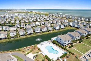 A residential area with houses, a lake, and a swimming pool. - My Happy Place by Brunswick Vacation Rentals: Cottage w/ Community Pool & Views (Ocean Isle Beach)