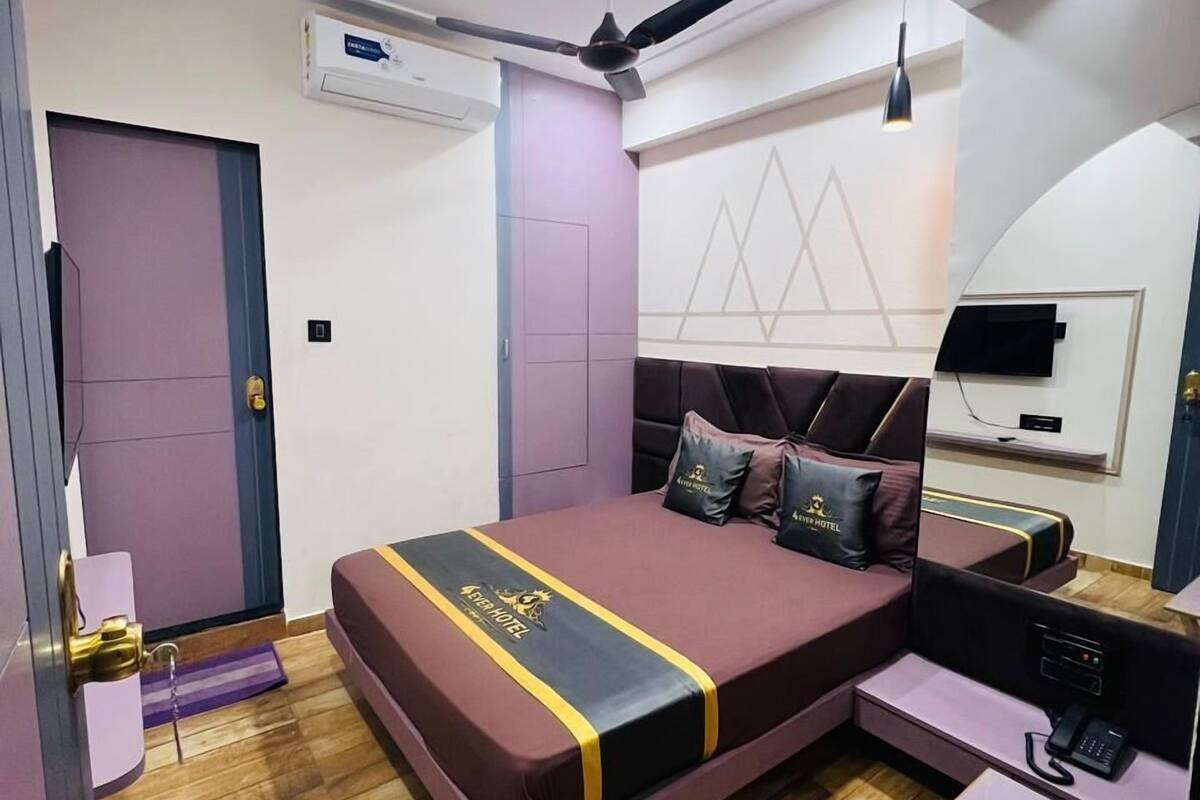 A modern bedroom with a bed, a desk, and a chair.