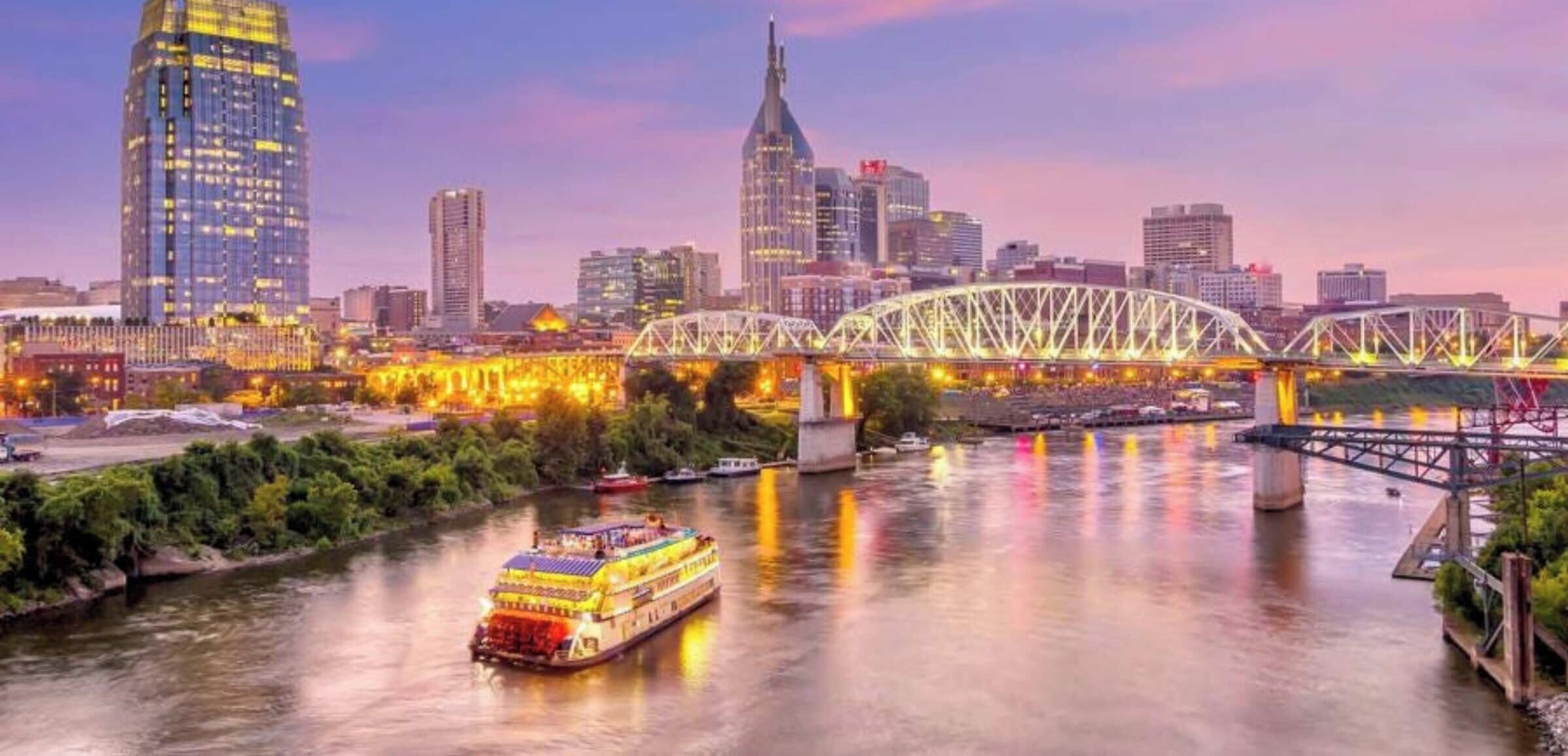 A river with a bridge and a city skyline in the background.