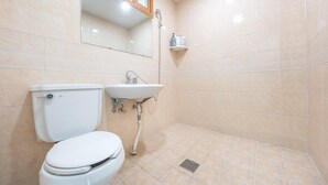 A bathroom with a toilet, sink, and shower. - Taean Yeonpo Haibada Pension (Taean)