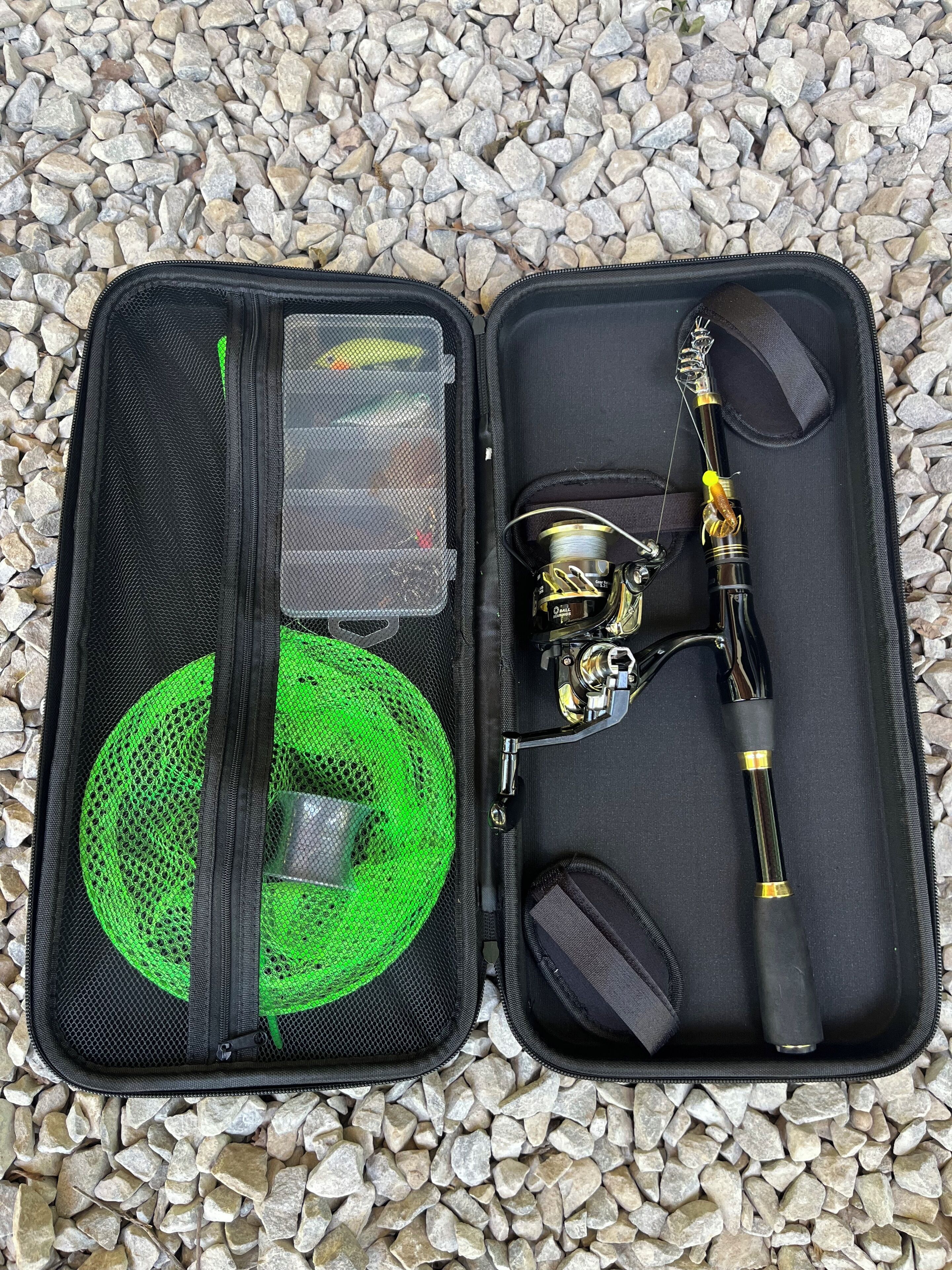 An open fishing tackle box with a green mesh pocket, a fishing rod, and a spool of fishing line.
