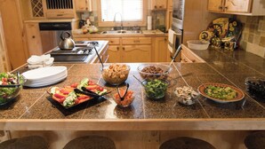 A kitchen counter with various food items and utensils. - Gilbert Creek Lodge, your Home Sweet Home in the Uinta's! (Mountain View)