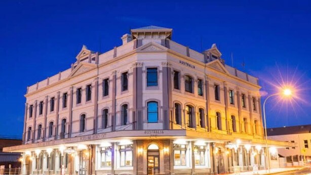 A historic building with "AUSTRALIA" signage, featuring a symmetrical facade with multiple windows and a central entrance. - Australia Hotel Fremantle (Fremantle)