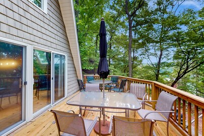 Cozy A-frame home with fire pit, deck, pickleball court, and covered boat slip