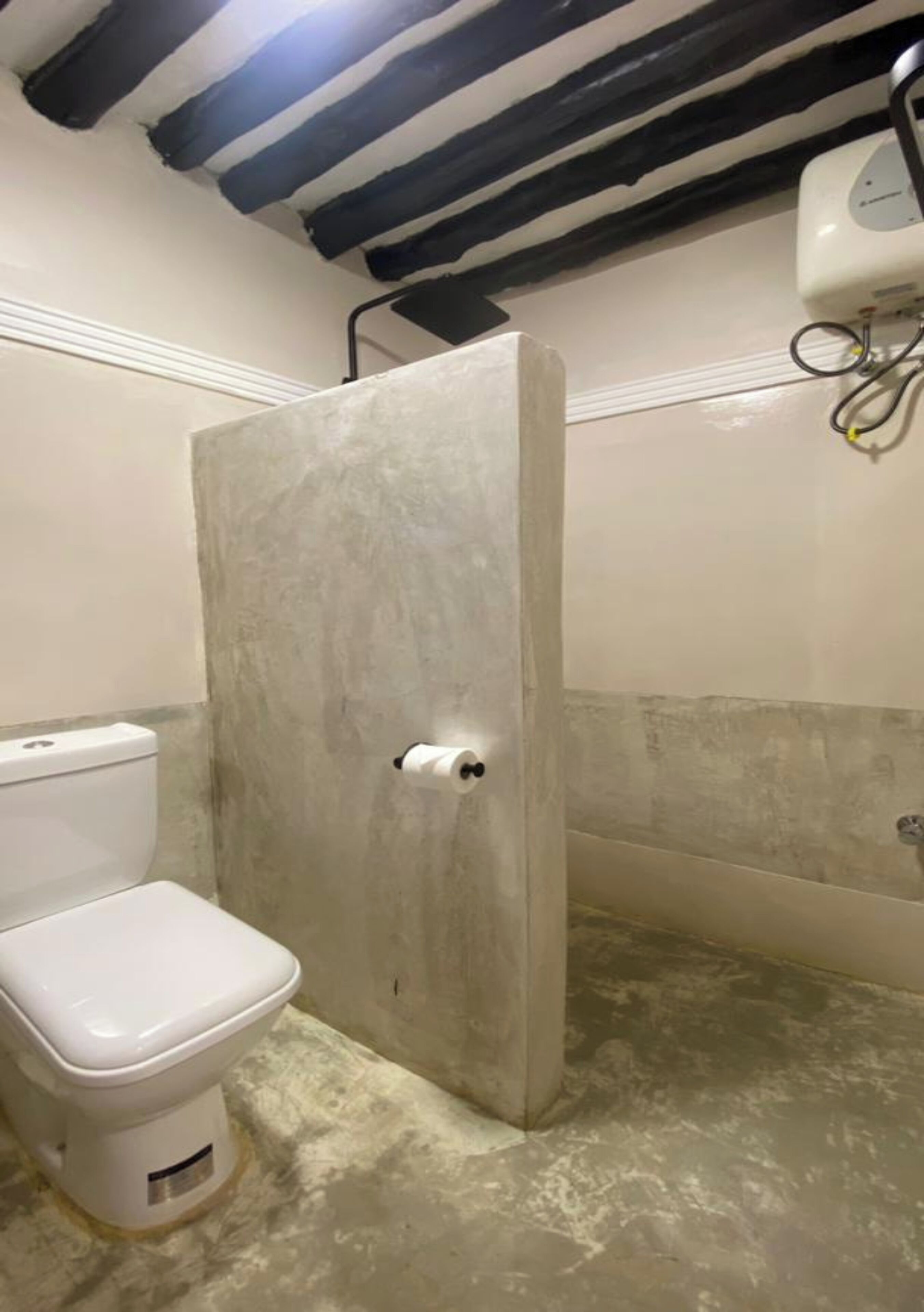 A bathroom with a toilet, a shower enclosure, and a towel rack.
