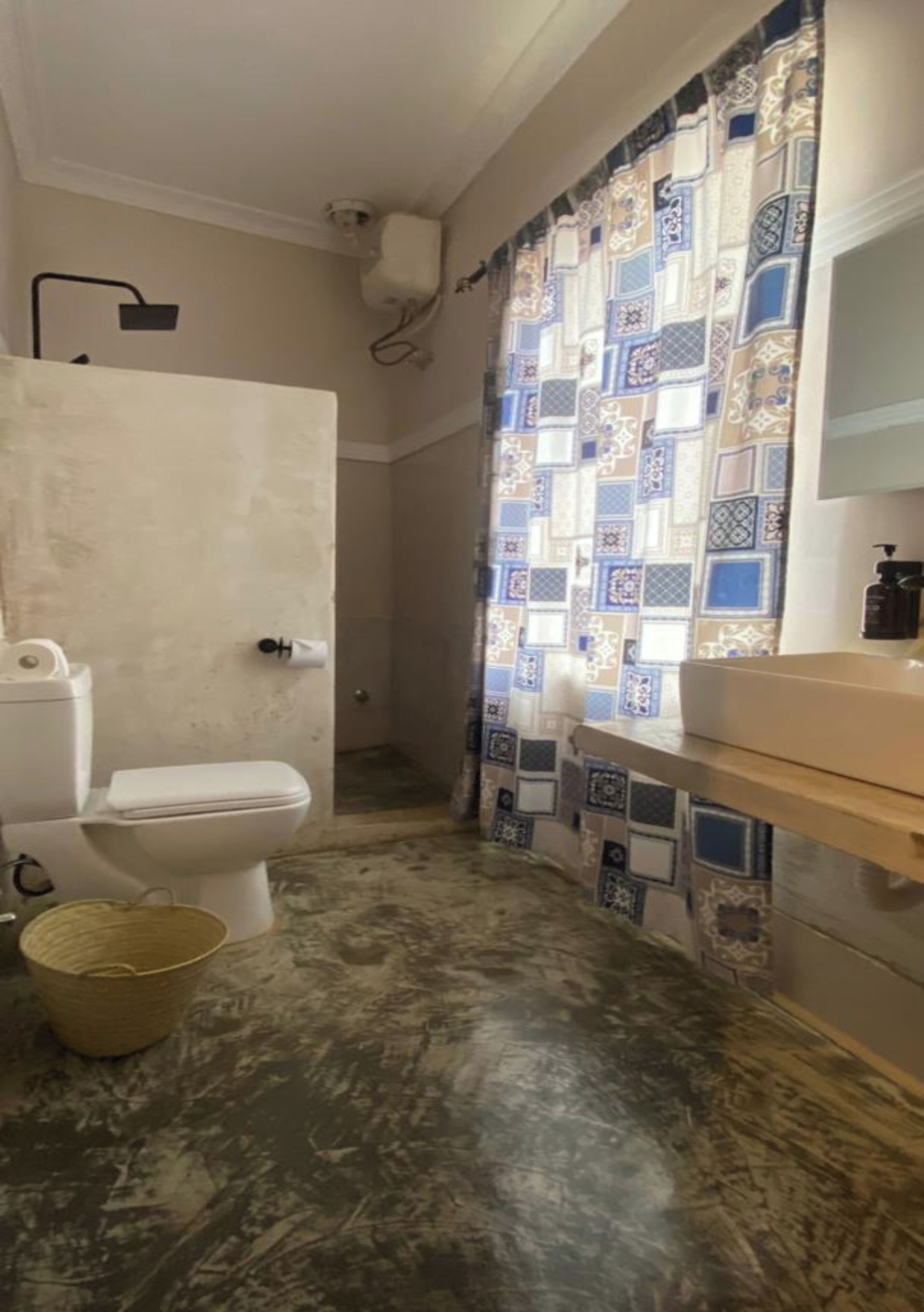A bathroom with a toilet, a sink, and a shower.