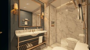 Un baño moderno con tocador de mármol, un espejo grande, ducha a ras de suelo y un inodoro.
