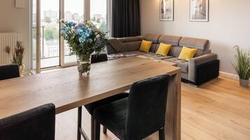 Deluxe Apartment, City View | Living area | 30-inch flat-screen TV with cable channels